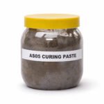 Tandoor oven Curing Paste AS05 – front view of clear plastic jar with yellow lid filled with dark grey-brown curing paste, showing white label reading AS05 CURING PASTE, on white background