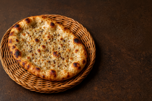 A freshly baked multigrain naan served on a plate, showcasing the golden brown texture and wholesome grains in this healthy multigrain naan recipe. for my post named as how to make multigrain naan