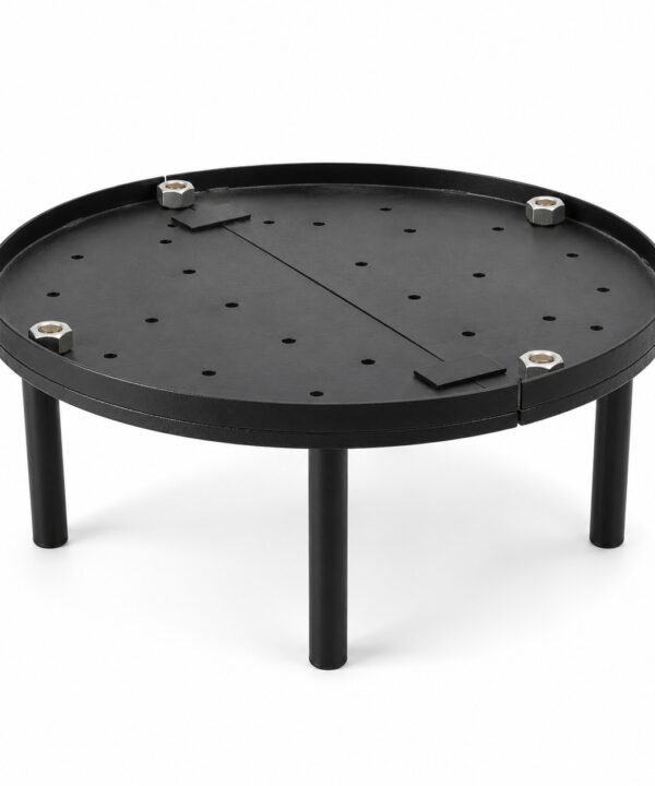 Tandoor Baffle Plate AS02 – fully assembled round black steel baffle plate on four legs, showing perforated surface with air-flow holes, centre divider bar, and four stainless steel hex bolt leg fasteners, angled three-quarter view on white background