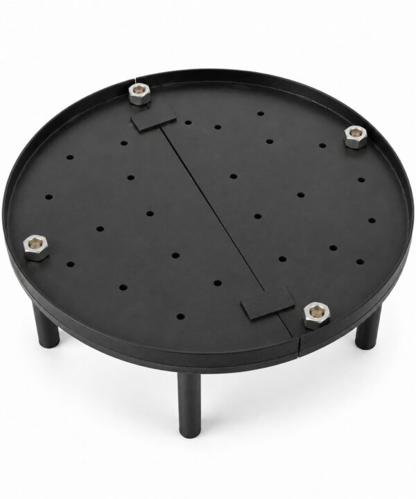 Tandoor Baffle Plate AS02 – overhead angled view of fully assembled standalone baffle plate showing round black steel perforated disc with evenly distributed air-flow holes, diagonal centre divider bar, four stainless steel hex bolt leg mounts, and four supporting legs on white background