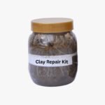 Tandoor Clay Pot Repair Kit AS08 – clear glass jar with gold lid filled with grey-brown repair clay mixture, showing white label reading Clay Repair Kit, on light grey background