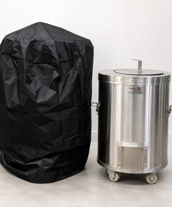 Tandoor Cover AS14 – studio shot on white background showing the black tandoor cover standing upright on the left next to an uncovered stainless steel cylindrical Morni tandoor oven on casters on the right, demonstrating the cover's size relative to the oven it is designed to protect