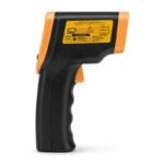 Tandoor Digital Thermometer Gun AS16 – clean side profile view of the thermometer gun on white background, showing the full yellow caution laser warning label with distance-to-spot ratio diagram, the orange housing body, black ergonomic pistol grip handle with trigger, and the rear sensor opening, giving a clear view of the gun's overall profile and label information