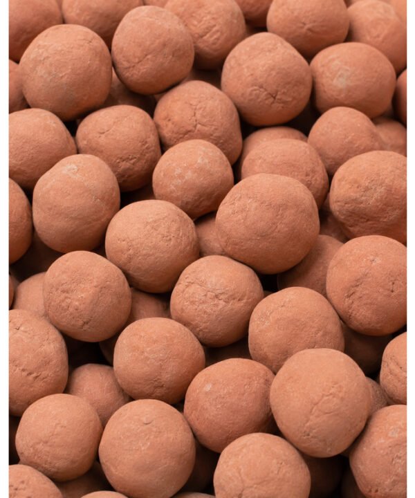 Tandoor Oven Clay Balls AS07 – macro close-up of a large pile of fired terracotta clay balls showing natural reddish-orange surface texture, small surface cracks, and varied matte finish typical of kiln-fired clay used inside a tandoor oven