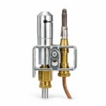 Tandoor Oven Thermocouple AS12 – straight-on front view of the pilot assembly unit on white background, showing the stainless steel cylindrical pilot nozzle with side gas port, thermocouple probe with stainless steel clip, brass igniter electrode, brass compression gas fittings at the base, and the steel U-channel mounting bracket that secures the assembly to the tandoor burner