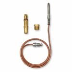 Tandoor Oven Thermocouple AS12 – flat-lay on white background showing the thermocouple probe and copper capillary tube with compression fitting, laid alongside the brass bullet-nose adaptor with red O-ring seal, brass hex reducing nut, and the stainless steel mounting clip, all individual components separated for clear identification