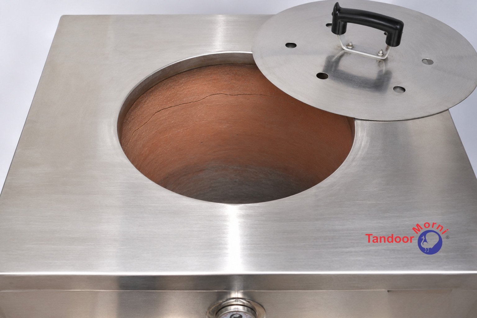 Signs of tandoor burner or clay damage: a hairline crack running across the interior clay wall of a tandoor oven