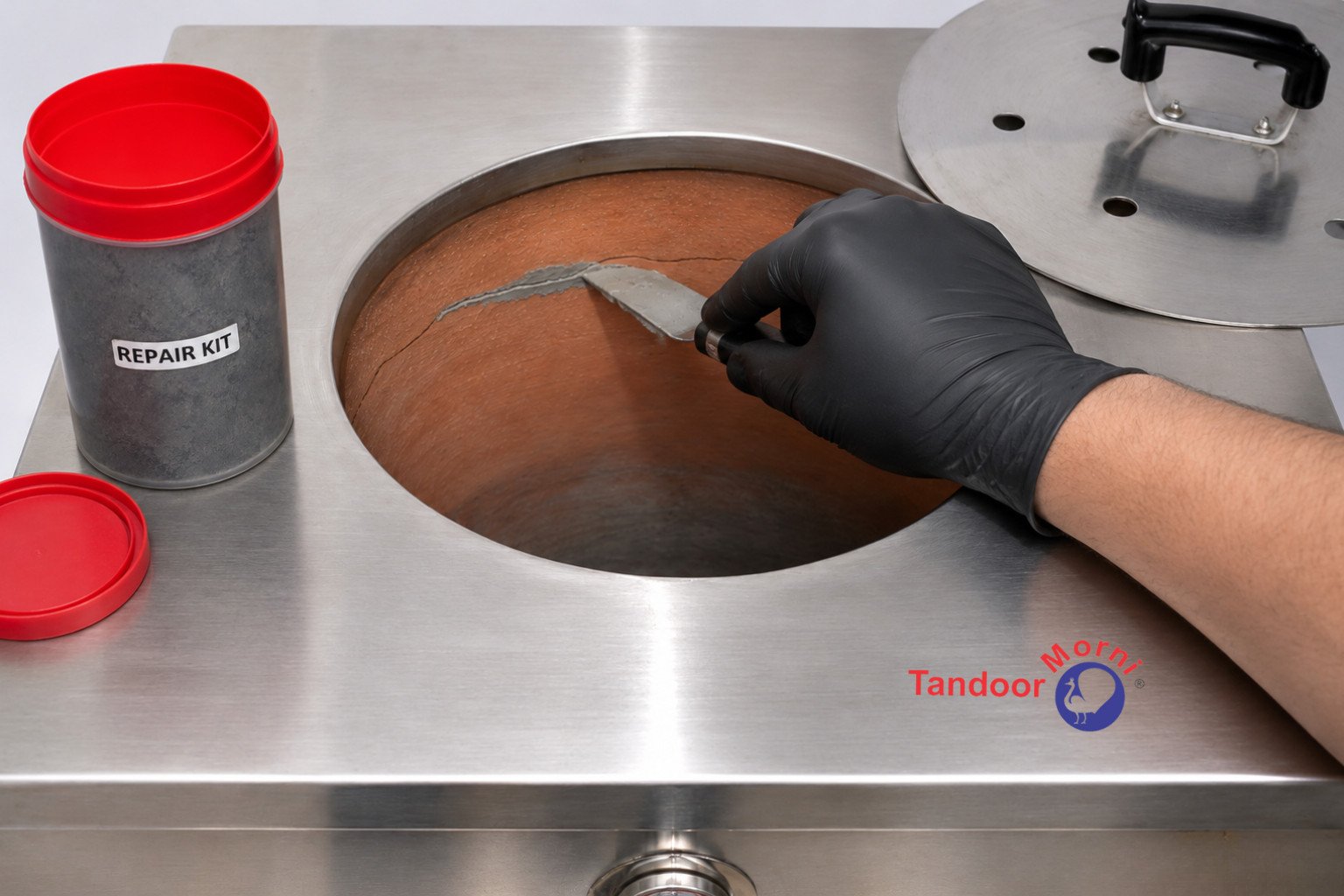 Tandoor damage warning signs: a clay tandoor pot repair kit being used to patch a crack in the interior wall