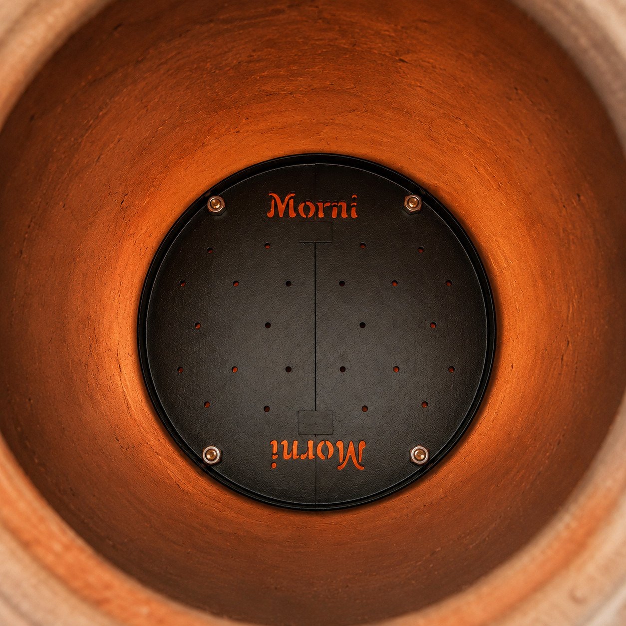 Tandoor Baffle Plate AS02 installed inside the base of a clay tandoor to regulate heat distribution