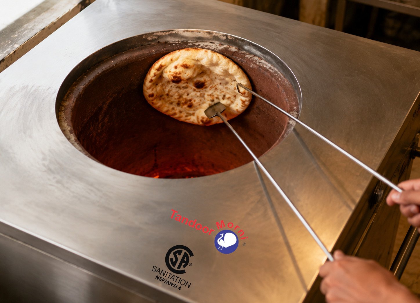 Naan bread tandoor oven recipe Step 6: naan puffed and charred on the tandoor wall, being lifted off with metal rods